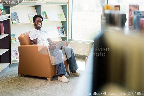 Image of Smiling Student With Digital Tablet In Library