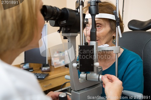 Image of Optometrist Examining Senior Woman's Eyes