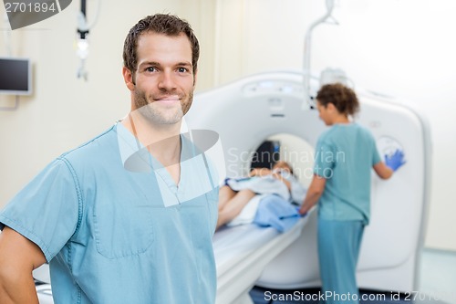 Image of Nurse With Colleague Preparing Patient For CT Scan In Hospital