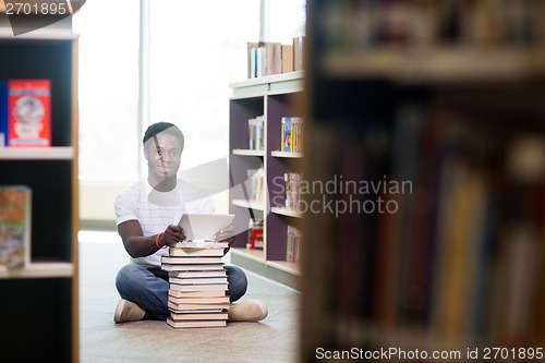 Image of Student With Digital Tablet And Books Sitting In Library