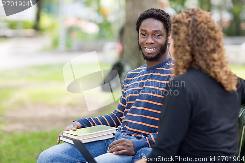 Image of Male Student Sitting With Female Friend On Campus
