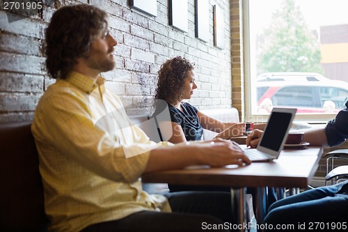 Image of Customers Spending Leisure Time In Coffeeshop