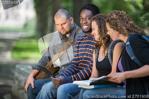 Image of University Student Sitting With Friends On Campus