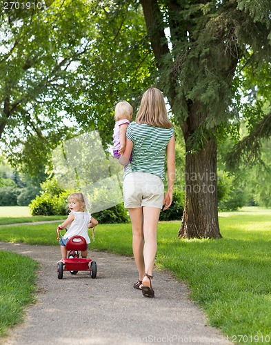 Image of Woman With Children Strolling In Park