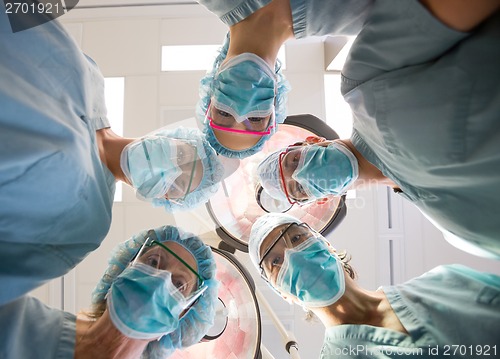 Image of Medical Team Wearing Masks And Scrubs In Operation Room