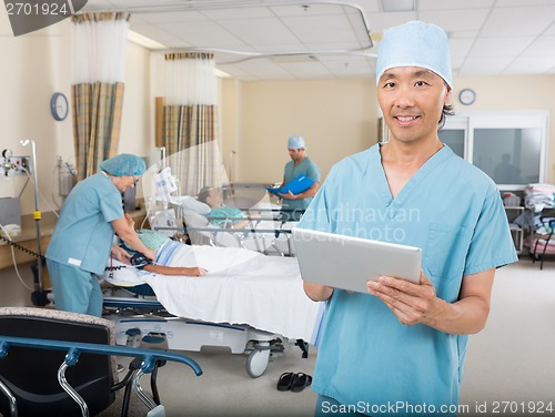 Image of Nurse With Digital Tablet Standing In Post Surgery