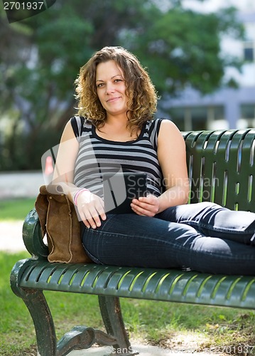 Image of Confident University Student Sitting On Bench