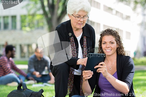 Image of Female University Student Using Digital Tablet With Friend