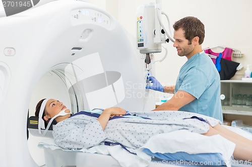 Image of Nurse Looking At Patient Undergoing CT Scan