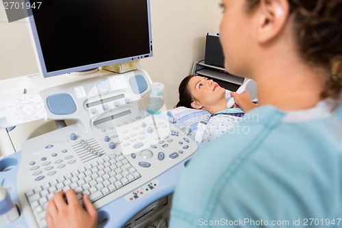 Image of Nurse Using Ultrasound Treatment On Patient's Neck