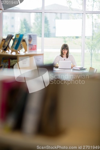 Image of Student Using Laptop In Library