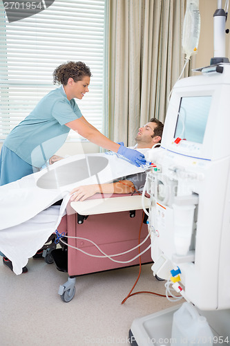 Image of Nurse Setting up Dialysis on male patient