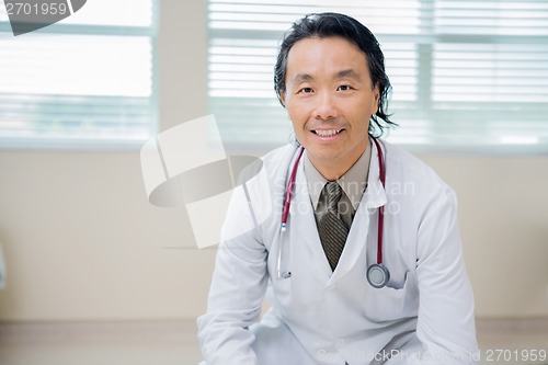 Image of Confident Cancer Specialist Sitting In Hospital Room