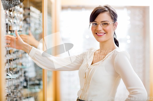 Image of Female Customer Buying Glasses At Optician Store