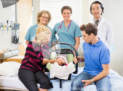 Image of Successful Medical Team With Newborn Baby And Parents In Hospita