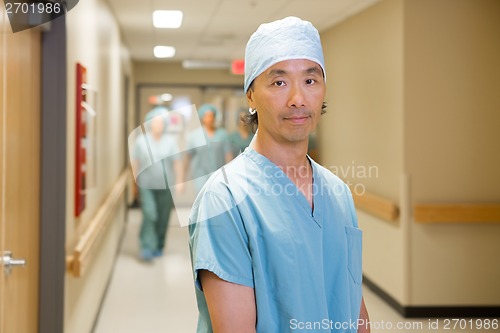 Image of Surgeon With Team Walking In Hospital Corridor