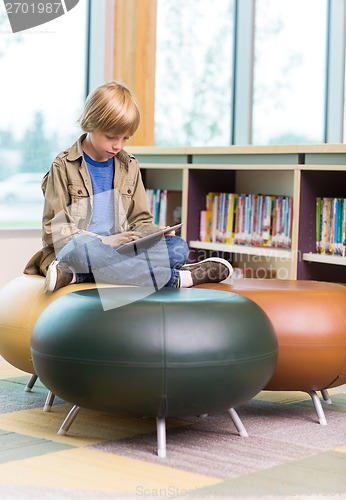 Image of Boy Using Digital Tablet In Library