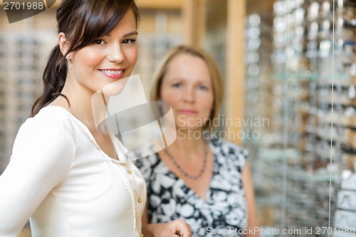 Image of Salesgirl With Senior Woman In Optician Store