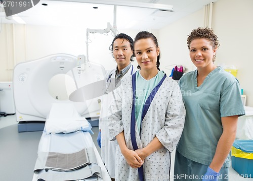 Image of Medical Team With Patient In CT Scan Room