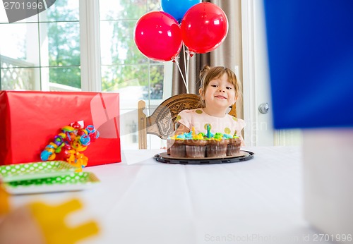 Image of Birthday Girl Looking At Presents At Home