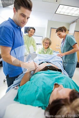 Image of Caring Man Holding Woman's Hand During Delivery In Hospital