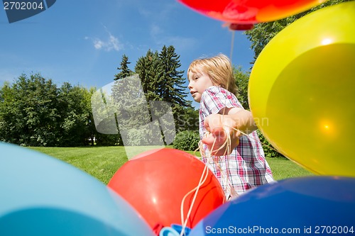 Image of Boy With Balloons Running In Park