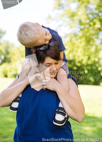 Image of Woman Carrying Son On Shoulders In Park