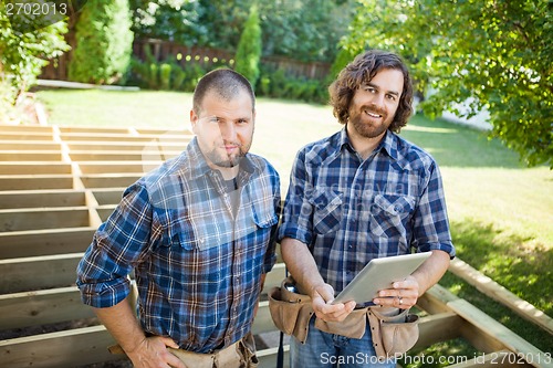 Image of Construction Workers With Digital Tablet At Construction Site