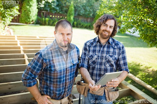 Image of Construction Workers With Digital Tablet At Construction Site