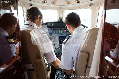 Image of Pilot And Copilot In Cockpit Of Corporate Jet