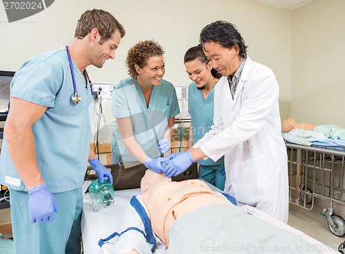 Image of Medical Team Adjusting Tube In Dummy Patient's Mouth