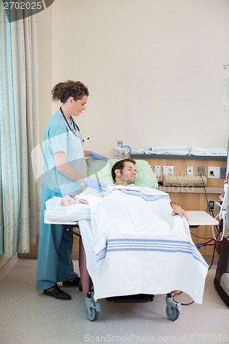 Image of Nurse Standing By Patient Receiving Renal Dialysis