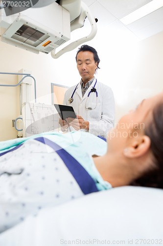 Image of Radiologist Using Digital Tablet In Examination Room