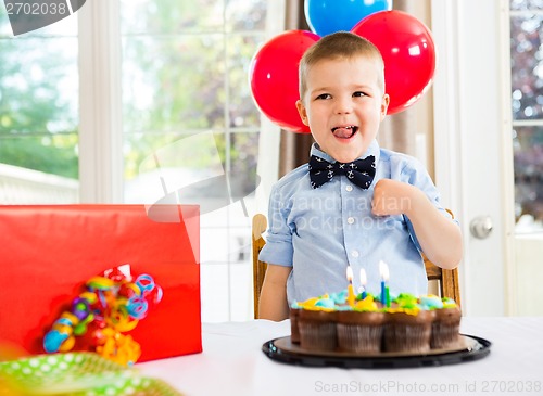 Image of Birthday Boy With Cake And Present On Table