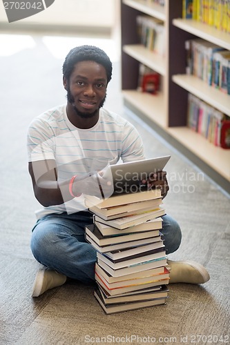 Image of Student With Books And Digital Tablet Sitting In Library