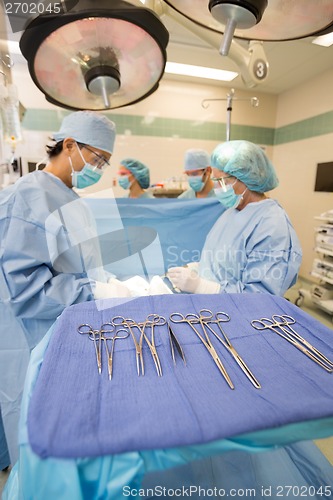 Image of Multiethnic Doctors Operating Patient