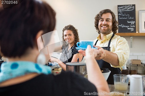 Image of Barista Serving Customer