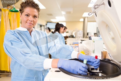 Image of Pretty Lab Tech Loading Centrifuge