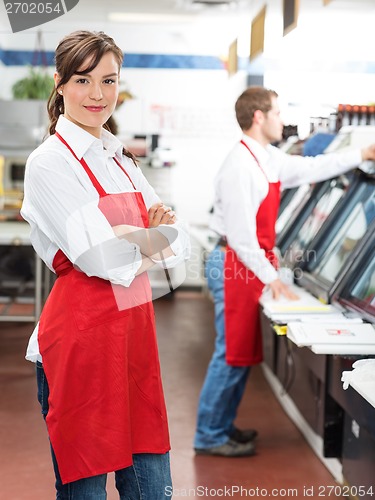 Image of Female Butcher Standing Arms Crossed At Store