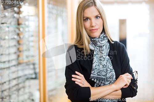 Image of Confident Woman Holding Glasses In Store