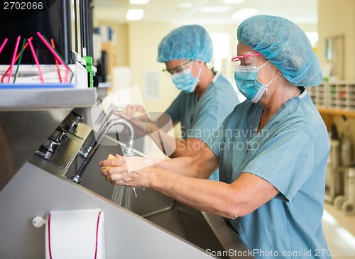 Image of Scrubbing Hands and Arms Before Surgery