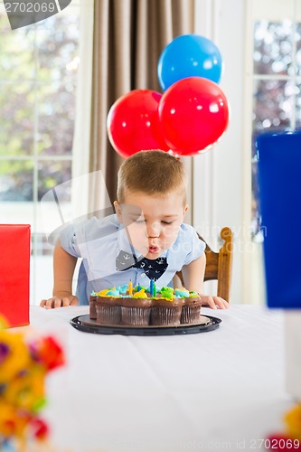 Image of Boy Blowing Candles On Cake