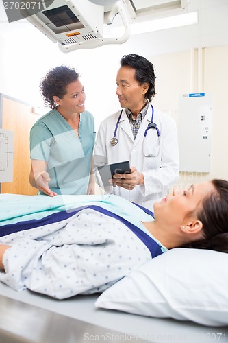 Image of Medical Team With Digital Tablet While Patient On Xray Table