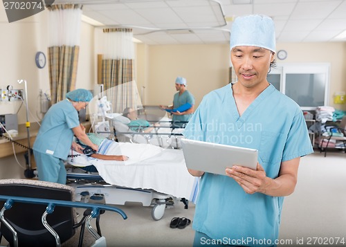 Image of Nurse Using Digital Tablet In Ward