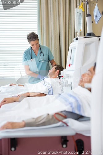 Image of Nurse Looking At Patient Undergoing Renal Dialysis