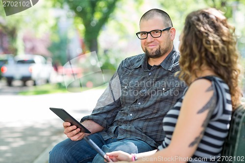 Image of Smiling University Student Sitting With Friend On Campus