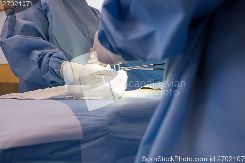 Image of Doctors Operating Young Patient