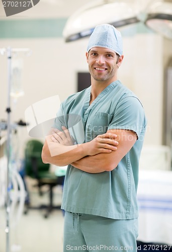 Image of Smiling Surgeon Standing Arms Crossed