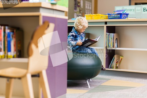Image of Boy Reading Book In Library