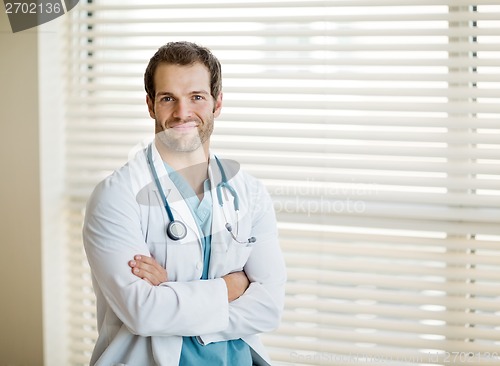 Image of Young Male Doctor Standing Arms Crossed